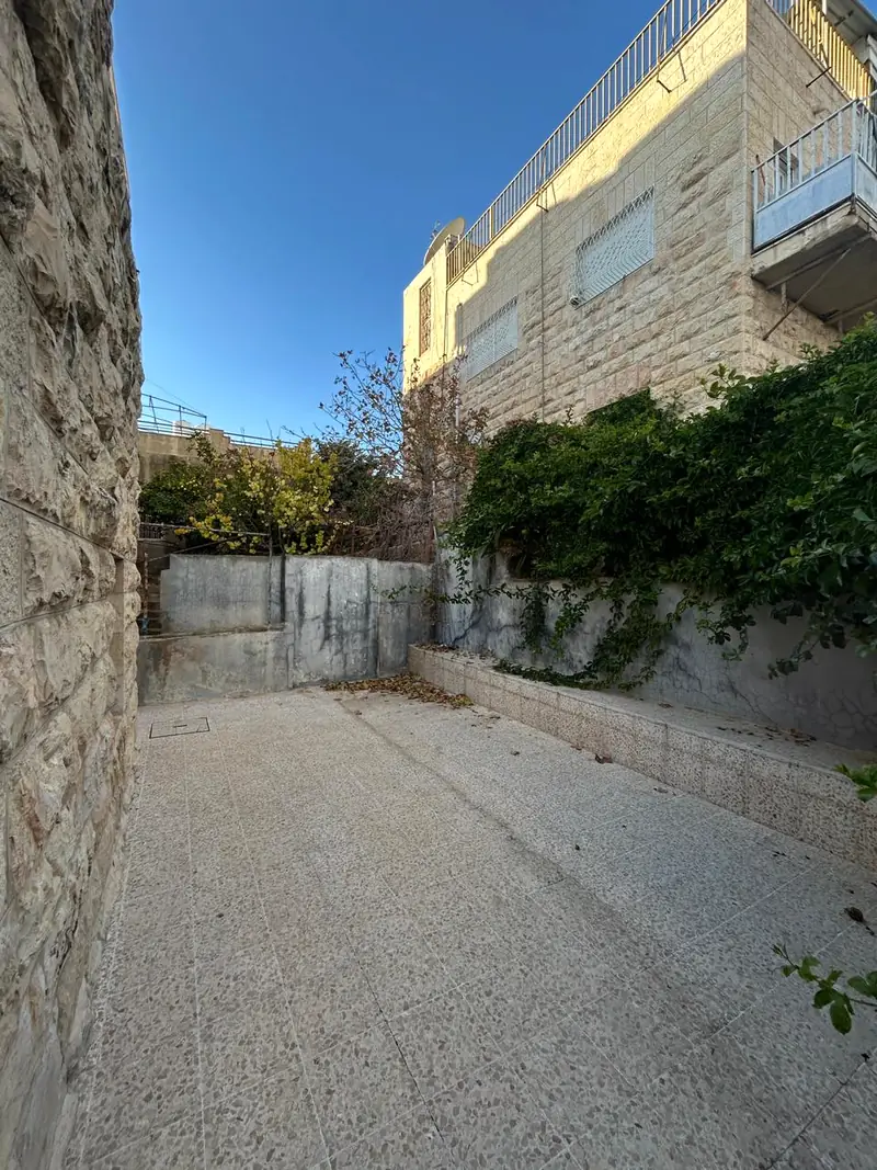 The stone courtyard of Dar Sidi under a blue sky